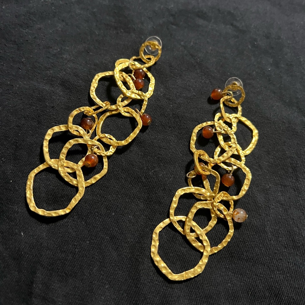 Long gold colored earrings